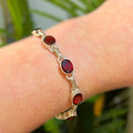 Oval Faceted Bezel Set Garnet Sterling Silver Bracelet